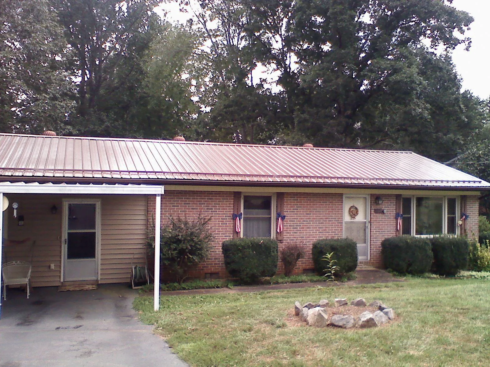 Bronze metal roof and carport on a brick ranch home — Roof Repair work by our crew in Abingdon